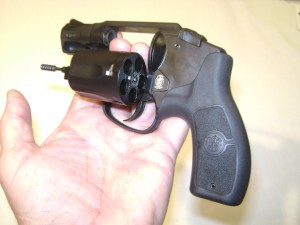 Double action only revolver with cylinder open. Ammunition goes in the holes (chambers) in the cylinder